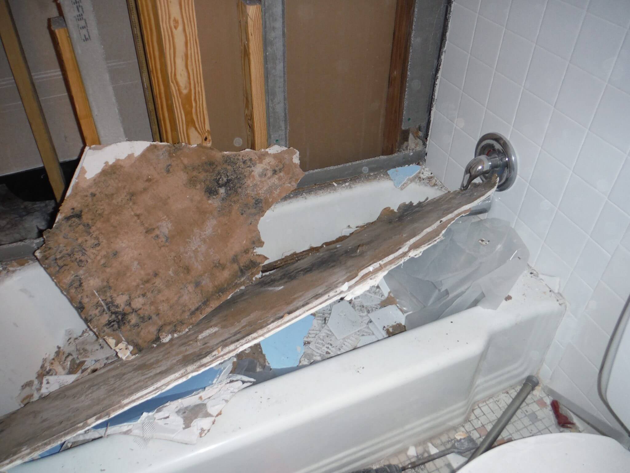 Water damage in bathroom. Drywall torn to reveal source of water damage and mold infestation